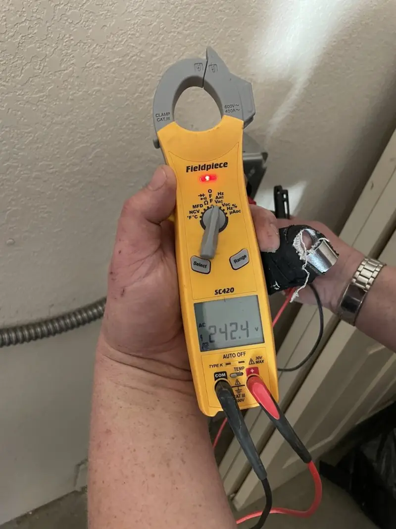 Voltage testing with clamp meter during Ceiling Fan Installation in Enterprise